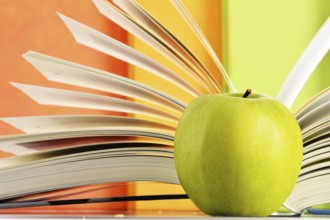 Composition with hardcover books and apple in the library