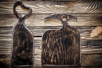 Two dark wood serving and chopping boards