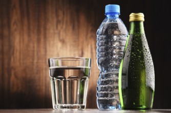 Composition with glass and bottles of mineral water