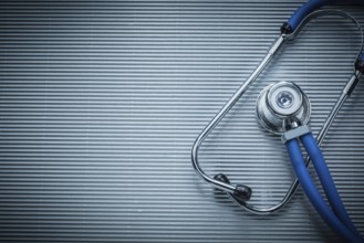 Medical auscultoscope on striped background