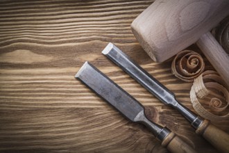 Carpenter's chisel and shavings on wooden board