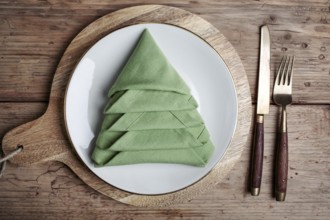 Plates with cutlery and festive decoration