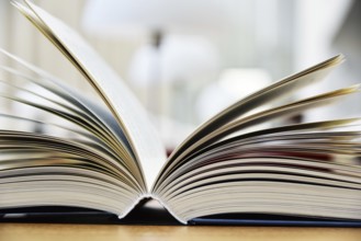 Hardcover book lying on the table in a library