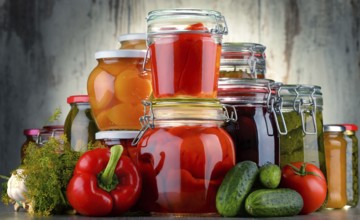 Jars with pickled vegetables and fruity compotes. Preserved food