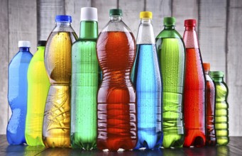 Plastic bottles of assorted carbonated soft drinks in variety of colors