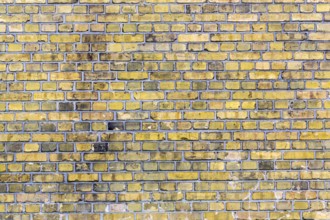 Old yellow brick wall for backgrounds