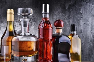 Composition with carafe and bottles of assorted alcoholic beverages