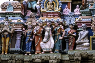 Stucco work portraying a woman about to deliver a baby in standing posture, Mallikeswarar temple in