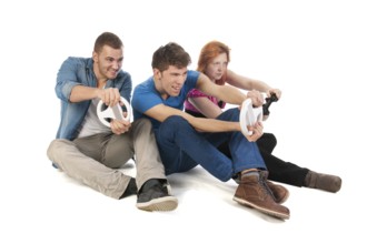 Three young friends ar gaming with the computer