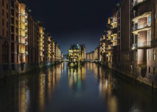 long exposure shot of canal in old warehouse district Speicherstadt in Hamburg, Germany at night