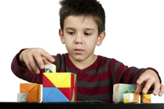 Little boy playing with multicolored cubes