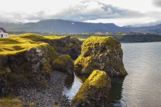Quiet summer evening on the coast of Iceland. Sunset in the fishing village of Arnastapi