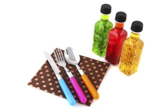Colorful dressing with herbs in glass bottles