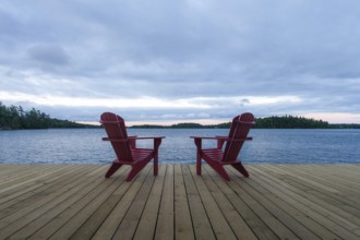Known as Muskoka or Adirondack chairs sit on a dock at a resort in Muskoka, Ontario, Canada, North