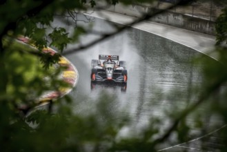 SANTINO FERRUCCI (14) of Woodbury, Connecticut comes through turn 12 (Canada Corner) during a wet