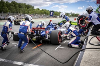 LINUS LUNDQVIST (R) (8) of Stockholm, Sweden comes down pit road for service during the XPEL Grand