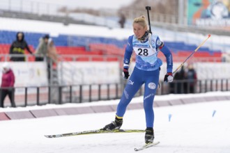 Sportswoman biathlete Petrunova Kseniya Kamchatka Region skiing on distance biathlon stadium. Open