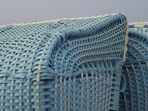 Close-up of a turquoise-coloured wicker beach chair, egmond, north sea, netherlands