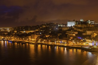 Overview of Old Town of Porto, Portugal at night. Ribeira and Douro river