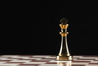 Golden king chess figure standing on chessboard. Intellectual and tactic game. Strategy planning,