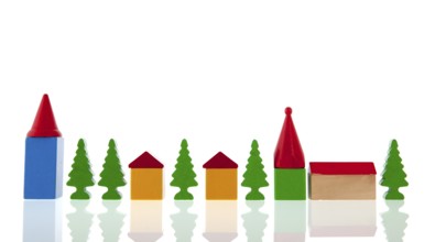 Small village in colorful wooden blocks with church and trees isolated over white background