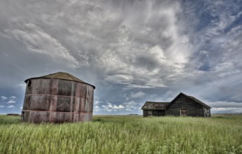 Abandoned Farm with storm clouds in the Canadian Prairie