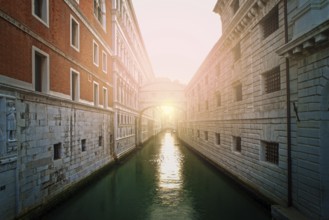 Ancient buildings and boats in the channel in Venice. Restaurant on foreground