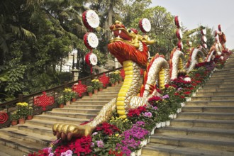 Traditionally decorated ladder in the Chinese park - a red dragon and bright flowers