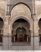 Fes, Morocco, April 05, 2023, Traditional oriental facade at the courtyard of madrasa Bou Inaniya