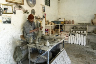 Fez, Morocco, 4 March, 2024: Moroccan potter at work in his pottery studio in downtown Fez northern