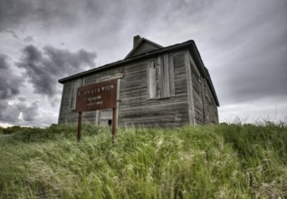 Abandoned Farm with storm clouds in the Canadian Prairie
