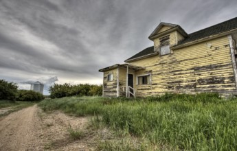 Abandoned Farm with storm clouds in the Canadian Prairie