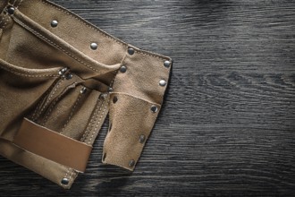 Leather tool belt on wooden board