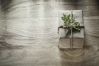 Handmade present box with thuya branch on wooden board