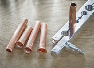 Flared pipes brake plumber on wooden board