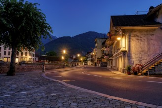 Empty street at twilight with illuminated buildings and street lights, city, vilage, cityscapes,