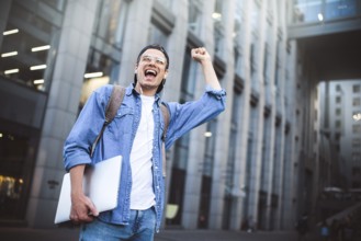 Man Sitting Listening Music Earphones Concept. Cheerful young guy listening the music