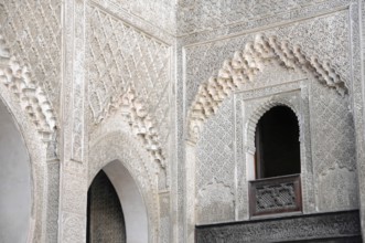 Fes, Northern Morocco, Morocco, Richly decorated wall with detailed patterns and a small window