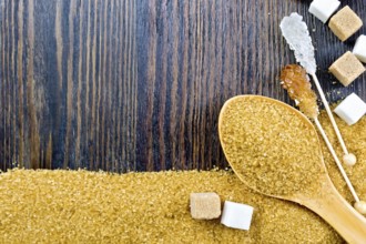 Sugar brown and white granules in a spoon, cubes and crystals on a stick in the form of a frame on