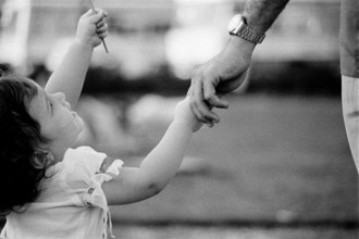 Baby infant girl holding father's hand Model release number 477