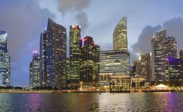 Singapore skyline at night. Buildings along Marina Bay