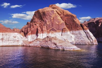 Lake Powell is surrounded by magnificent red hills. Walk on the boat at sunset. Scenic huge