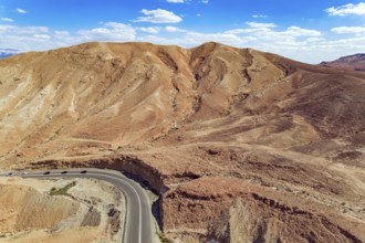 Judean desert on the shores of the Dead Sea. Dry waterless hills of yellow, beige and gray clay.