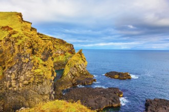 Scenic fjords on a cloudy summer day. Rocks covered with moss. Gorgeous Iceland. North sea coast