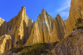 Elderly man takes pictures in the gorge. The Clay Cliffs are tall pinnacles separated by narrow