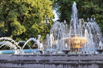 An old fountain with a large bowl in the centre and jets of different shapes in the resort park of