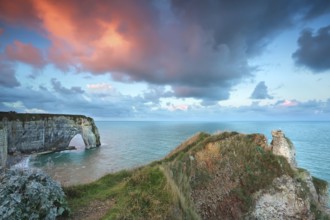 Dramatic purple sunrise over Atlantic ocean coast, Etretat, France