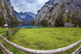 The concept of active tourism and ecotourism. Bavarian Alps. Magic blue lake Obersee and fenced