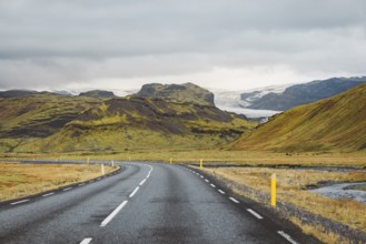 Road and mountain view during road trip in iceland. Foggy landscape in autumn time.