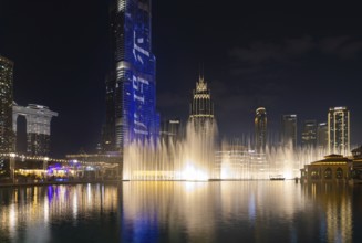 A picture of the Dubai Fountain light and water show at night